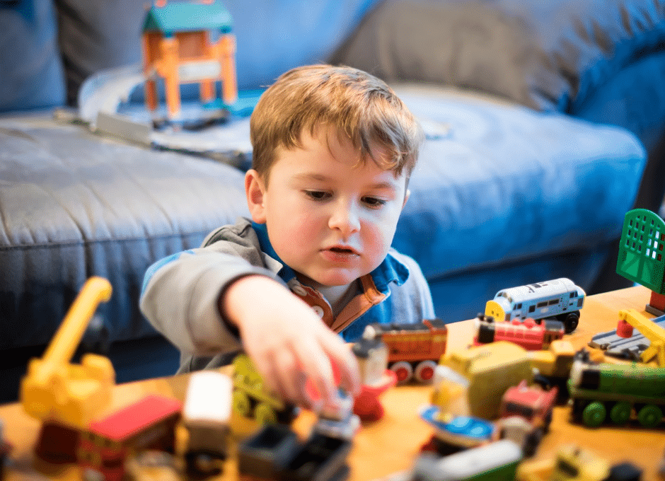 child playing with toys on coffee table