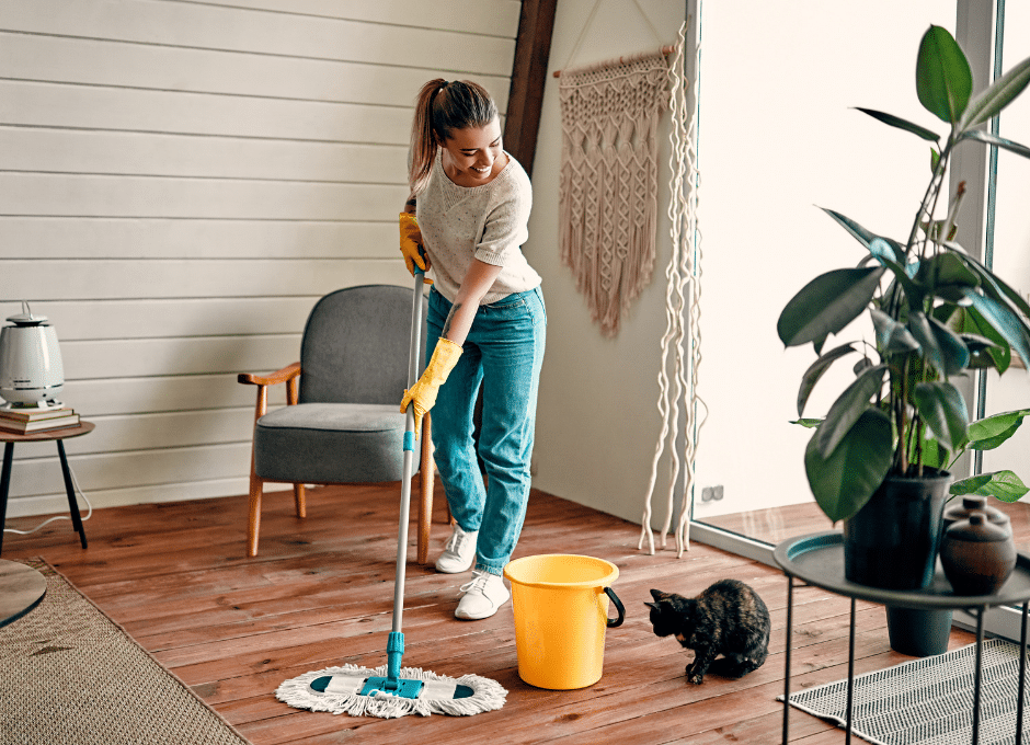 woman mopping with cat