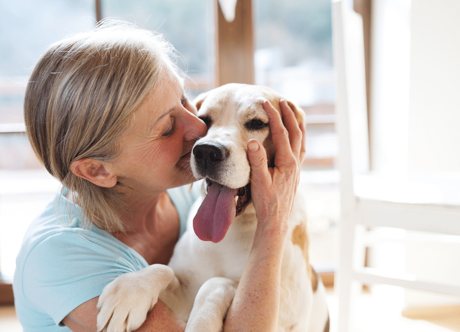 woman petting dog in home