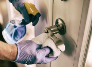 woman cleaning door handle