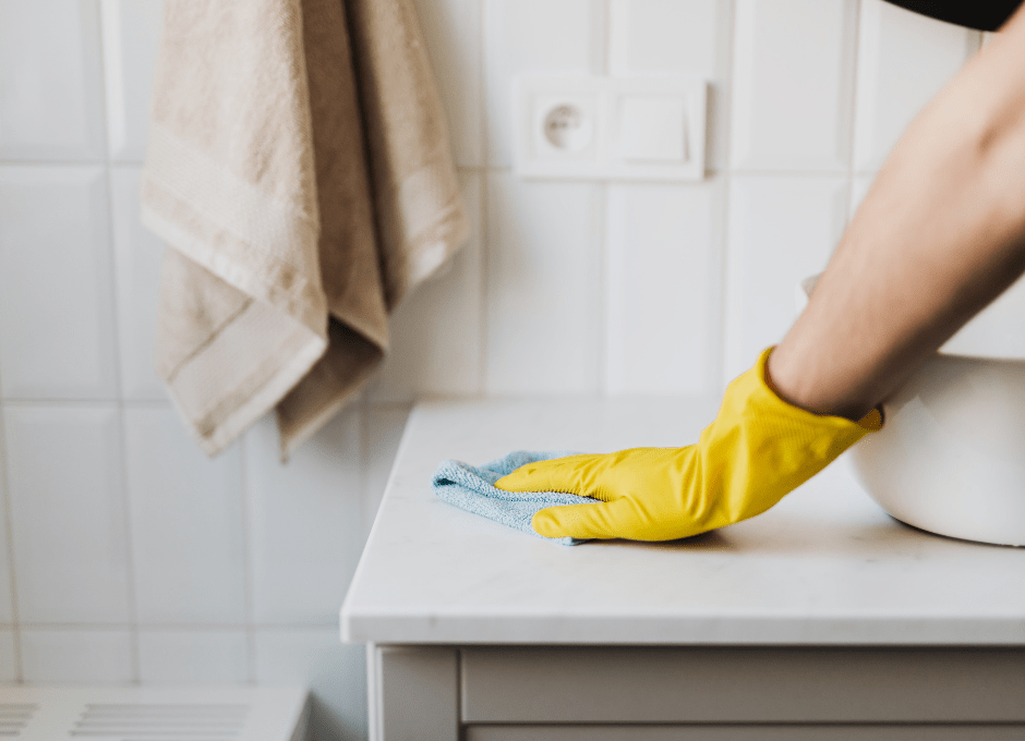 close up of hand wiping clean bathroom counter