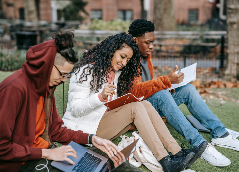 college students sitting outside studying