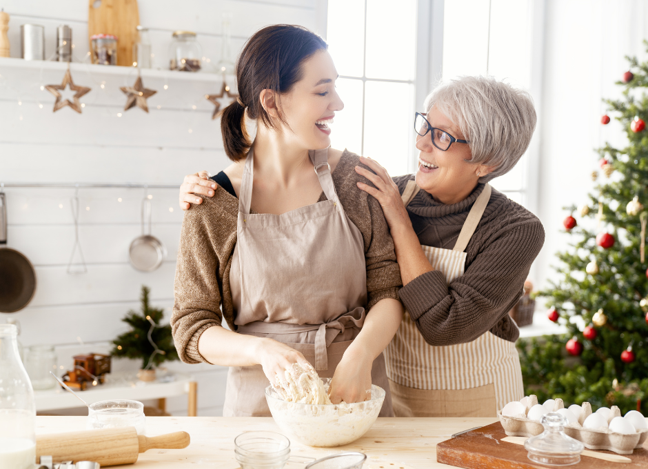 woman kneading dough with mom in Christmas kitchen