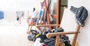 chair with laundry and messy room