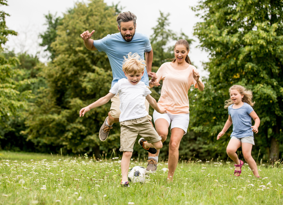 family outside playing soccer