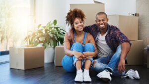 Couple sitting in space with moving boxes