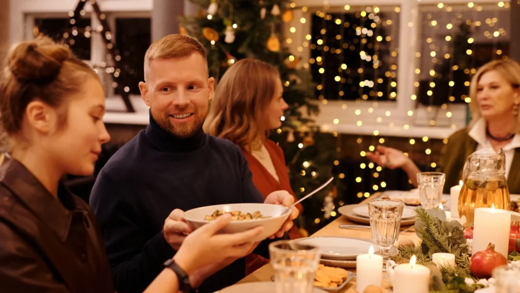 Family sitting at table with Christmas decor