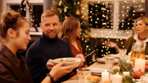 Family sitting at table with Christmas decor