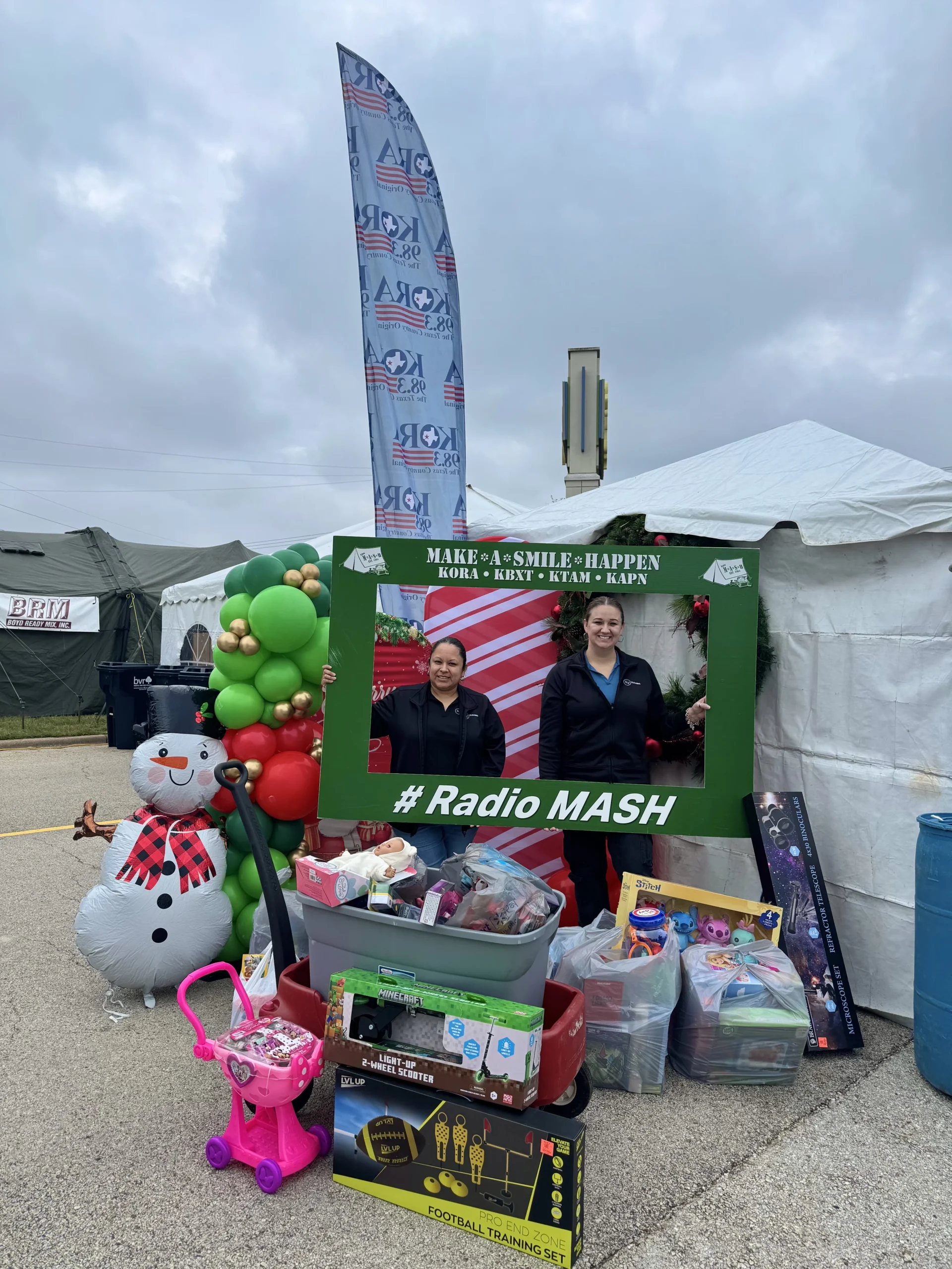 Team members holding up MASH sign for toy drive